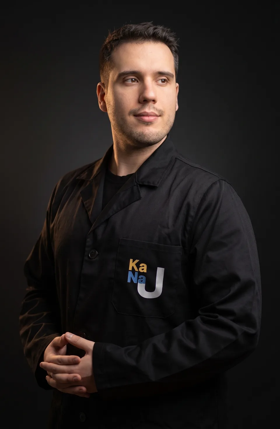 Adrian - korepetytor chemii, doktorant UJ, w czarnym fartuchu laboratoryjnym
